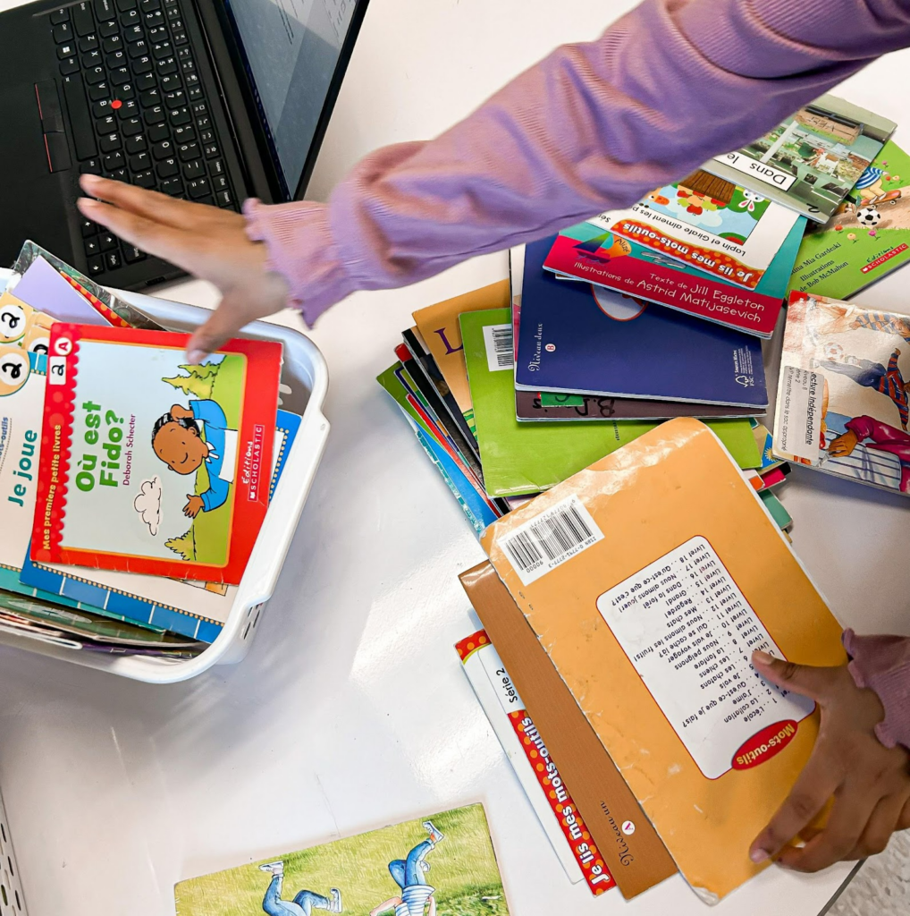 Primary student organizing classroom library books